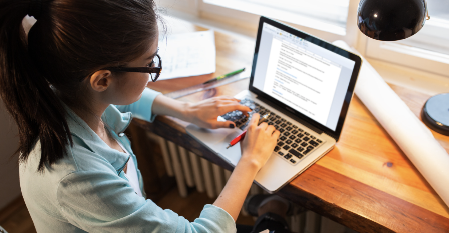 girl on computer taking notes